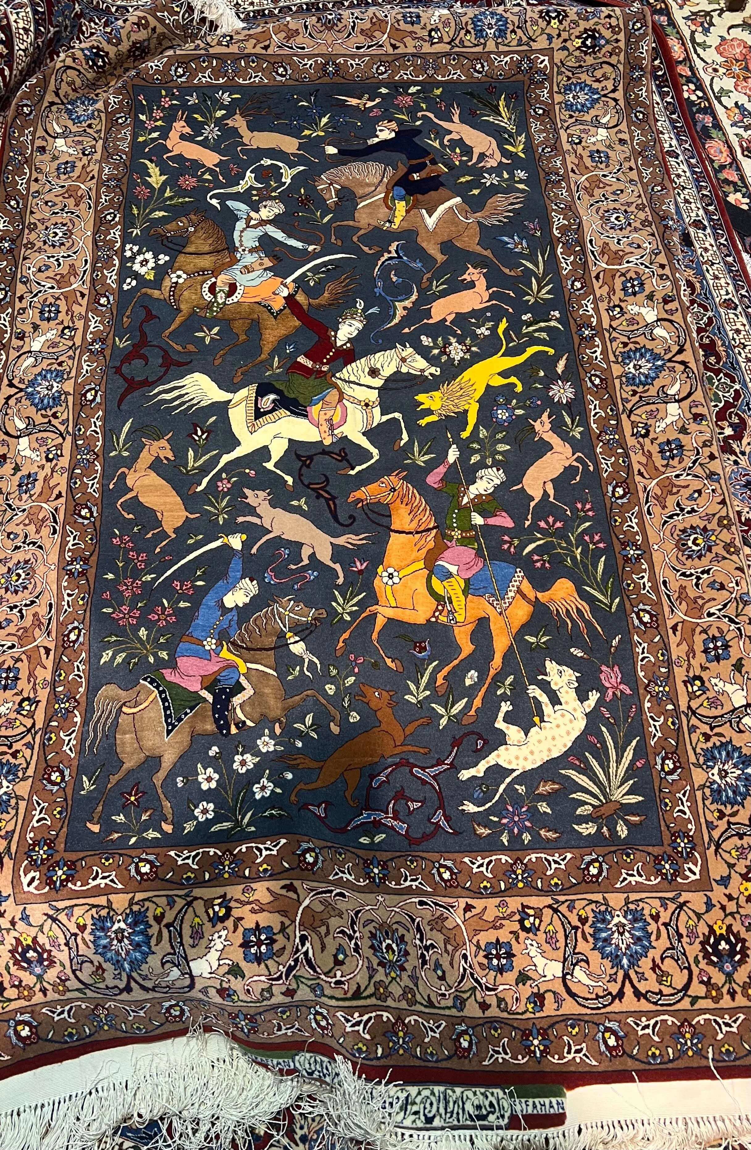 Exquisite hand-knotted Seirafian rug with a detailed central hunting motif.